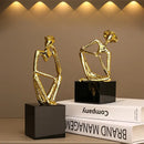Abstract golden hat thinker figure living room gold & black decor