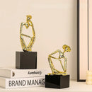 Abstract golden hat thinker figure living room gold & black decor