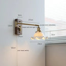 Adjustable brass wall sconce with ribbed glass shade bedroom light