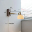 Adjustable brass wall sconce with ribbed glass shade bedroom light
