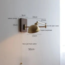 Adjustable brass wall sconce with ribbed glass shade bedroom light