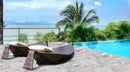 Alaska Silver Travertine Pattern Tumbled Pavers - Full Truckload ocean view next to swimming pool 2 modern rattan brown sunbeds 
