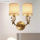 Antique brass antler wall sconce with fabric shade – bedroom light