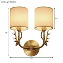 Antique brass antler wall sconce with fabric shade – bedroom light