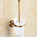 Antique brass bathroom set with ornate mounts and ceramic brush cup
