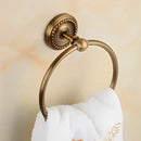 Antique brass bathroom set with ornate mounts and ceramic brush cup