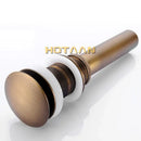 Antique brass sink drain with white rubber seal – bathroom waste