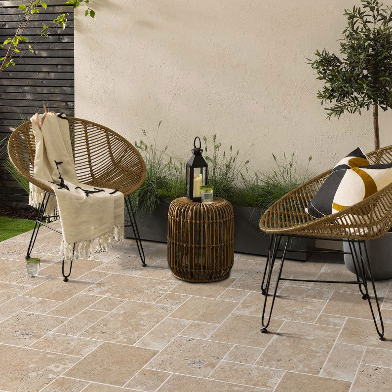 aspendos beige travertine pavers pattern installed on patio floor with 2 modern chairs