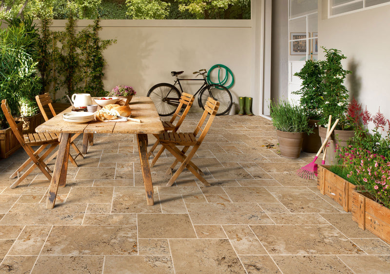aspendos beige travertine pavers pattern installed on patio floor wooden dinner table and chairs