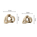 Beige speckled geometric interlocking loop knot living room sculpture