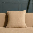 Beige textured quilted sofa cover with pillows for living room