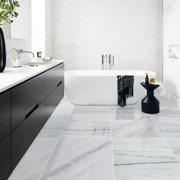 bianco lasa white exotic marble 24x24 polished installed modern bathroom floor white bathtub closeup