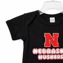 Nebraska Huskers N Onesie | Black | Multiple Sizes | Lou's Sporting Goods | 25N5IC