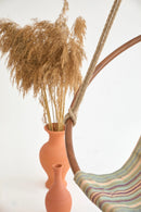 boves rast blue hanging round chair teak frame product shot closeup orange vases