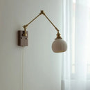 Brass walnut wall light with ribbed glass shade for bedroom