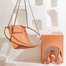 bresse rast blue hanging round chair teak frame orange vases decorative angle shot