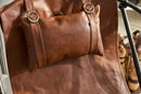 brown foldable metal frame faux leather chair black metal frame product shot closeup view