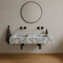 Calacatta Viola Marble Bathroom Double Sink Vanity (W)22" (L)67" (H)8" Polished  installed to a simple bathroom with round mirror plant on the corner and black wall-mount faucets