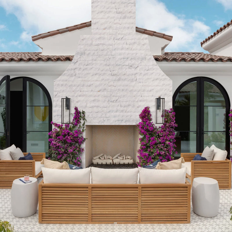 Carrara White 4"xFree Length Split-face Natural Marble Wall Tile - Belair Collection installed around outdoor fireplace outdoor wooden patio furniture