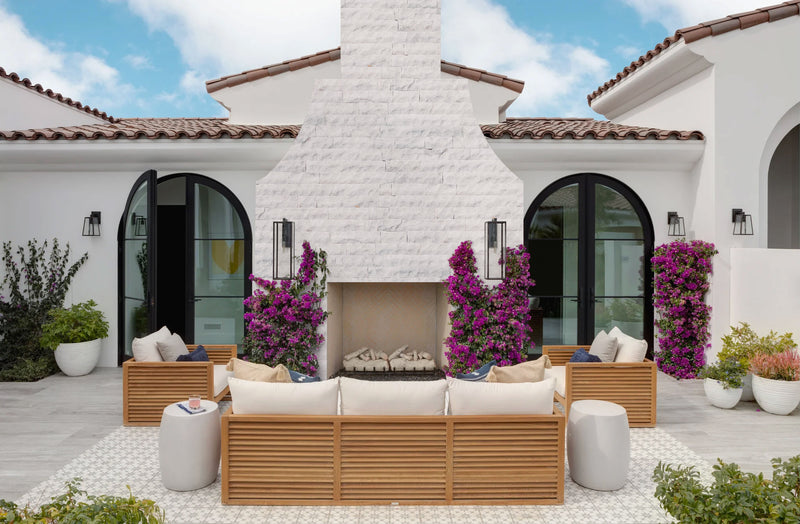 Carrara White 4"xFree Length Split-face Natural Marble Wall Tile - Belair Collection installed around outdoor fireplace outdoor wooden patio furniture wide view