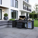 Outdoor kitchen setup with grill and refrigerator in a modern patio setting.