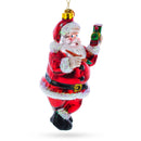 Santa Decorating the Train Glass Christmas Ornament