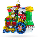 Playful Penguins Riding Train Glass Christmas Ornament