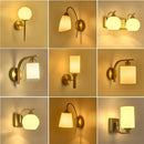 Classic brass glass wall sconce with frosted shade for bedroom