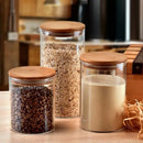 Clear glass storage jars with bamboo lids for kitchen organization