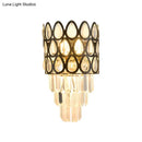 Contemporary black & gold sconce with teardrop crystals living room