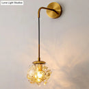Contemporary brass clear glass wall lamp with foil flower decor bedroom