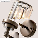 Contemporary bronze wall sconce with ribbed crystal shade hallway light fixture