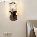 Contemporary bronze wall sconce with ribbed crystal shade hallway light fixture