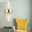 Contemporary gold wall light with clear crystal shade – living room