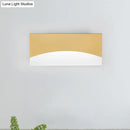 Contemporary white & gold bedroom sconce with warm color temperature
