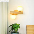 Contemporary white milk glass wall lamp with wooden base for bathroom