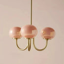 Cream pink bedroom pendant light with three glass globes and brass