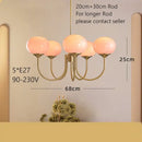 Cream pink bedroom pendant light with three glass globes and brass