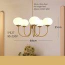 Cream pink bedroom pendant light with three glass globes and brass