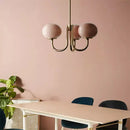 Cream pink bedroom pendant light with three glass globes and brass