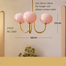 Cream pink bedroom pendant light with three glass globes and brass