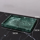Dark green marble bathroom accessory set with gold accents