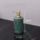 Dark green marble bathroom accessory set with gold accents
