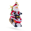 Santa Delivering Gifts on a Snowmobile Glass Christmas Ornament