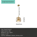 Modern amber glass chandelier with brass accents for living room