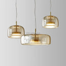 Modern amber glass chandelier with brass accents for living room