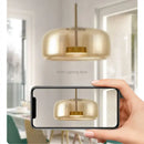 Modern amber glass chandelier with brass accents for living room