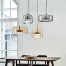 Modern amber glass chandelier with brass accents for living room