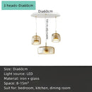Modern amber glass chandelier with brass accents for living room