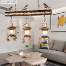 DecorBites™ Antique Brass Lantern Pendant with Clear Glass and Bird Accent - 3-Light Coastal Island Kit